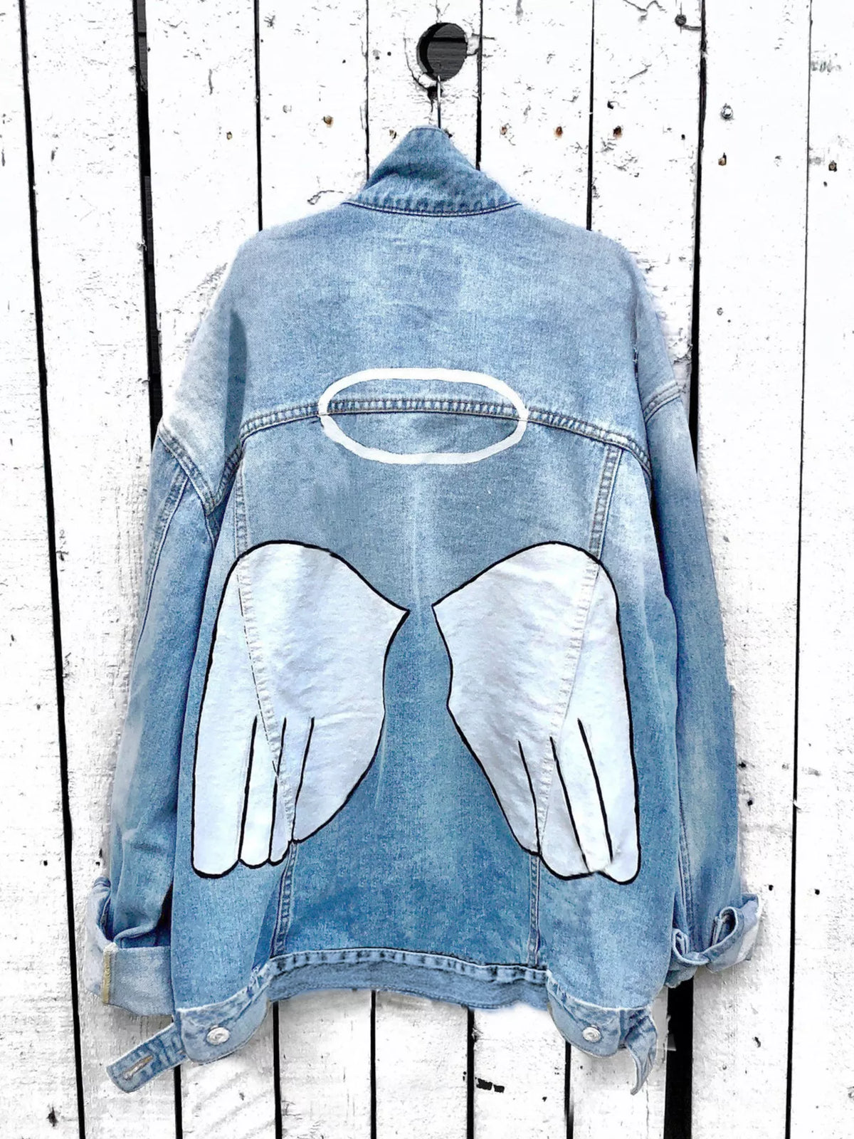 Plus size denim jacket with angel wings graphic back design from Trendsi, featuring full-size angel wing print on the back.