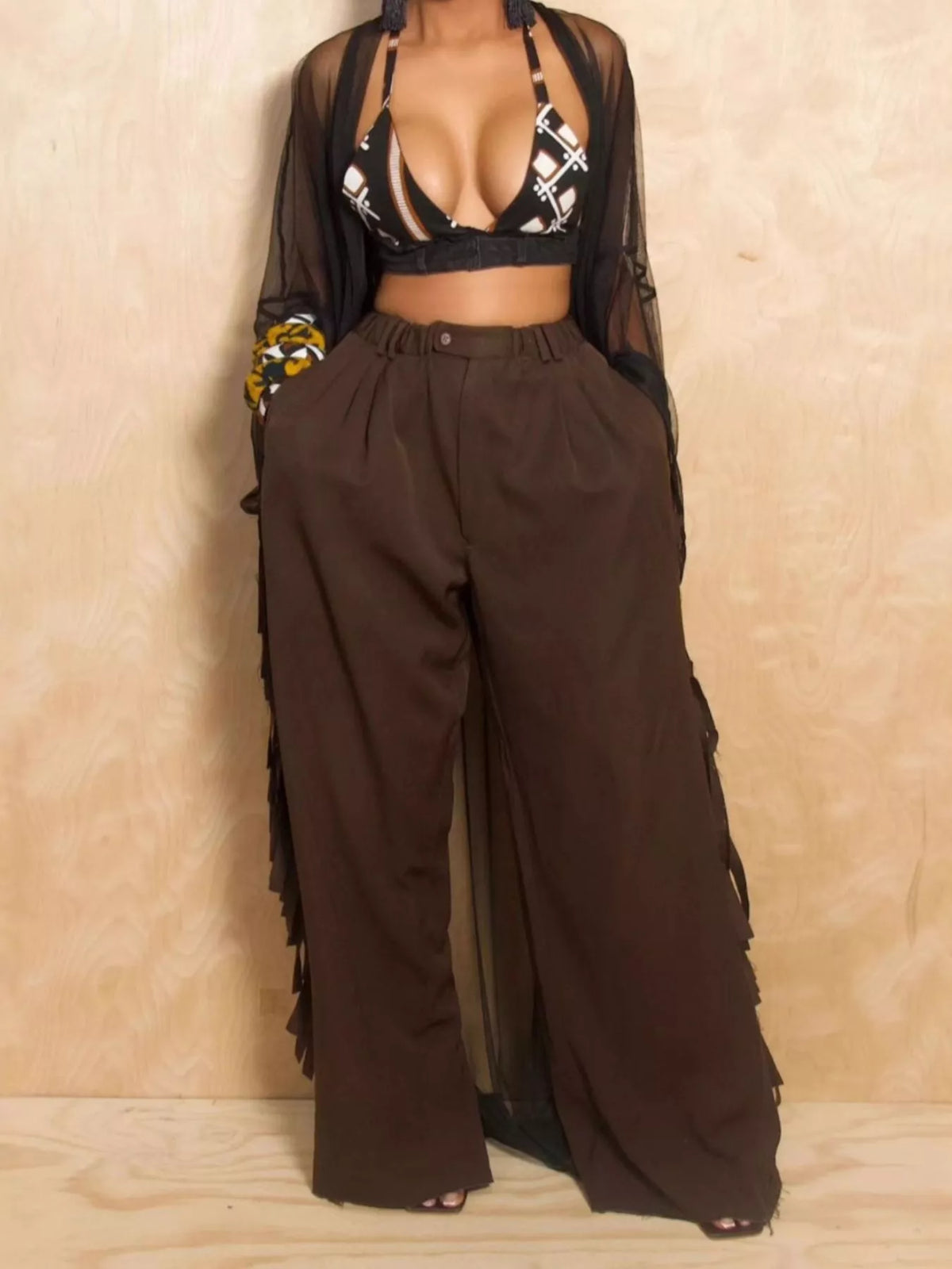 Wide-leg women's pants with fringed details, featuring flowy fabric and stylish design, perfect for casual or boho fashion.