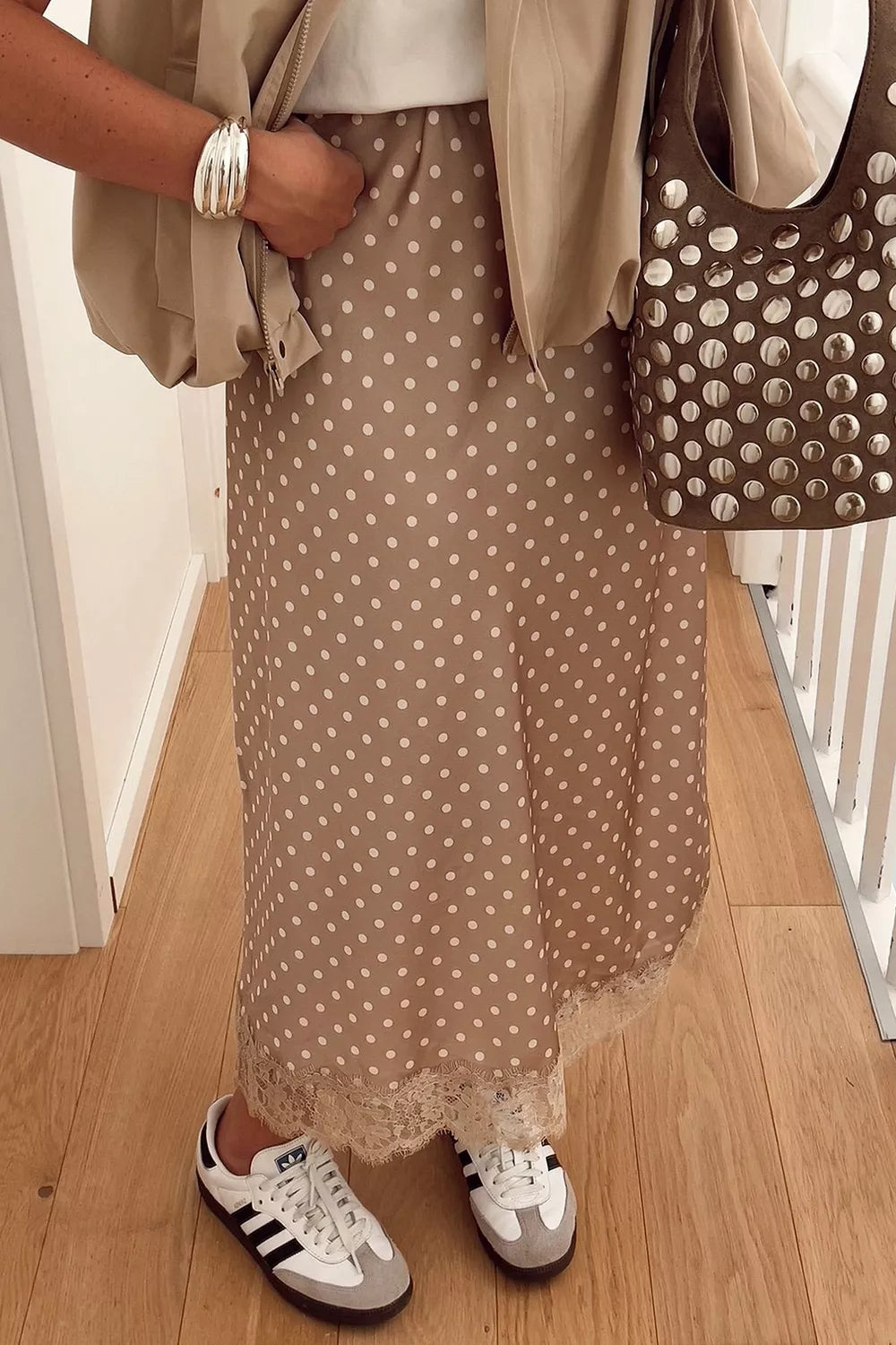 Women's polka dot lace trim midi skirt by Trendsi, featuring a flowy silhouette and stylish details, shown in the image.