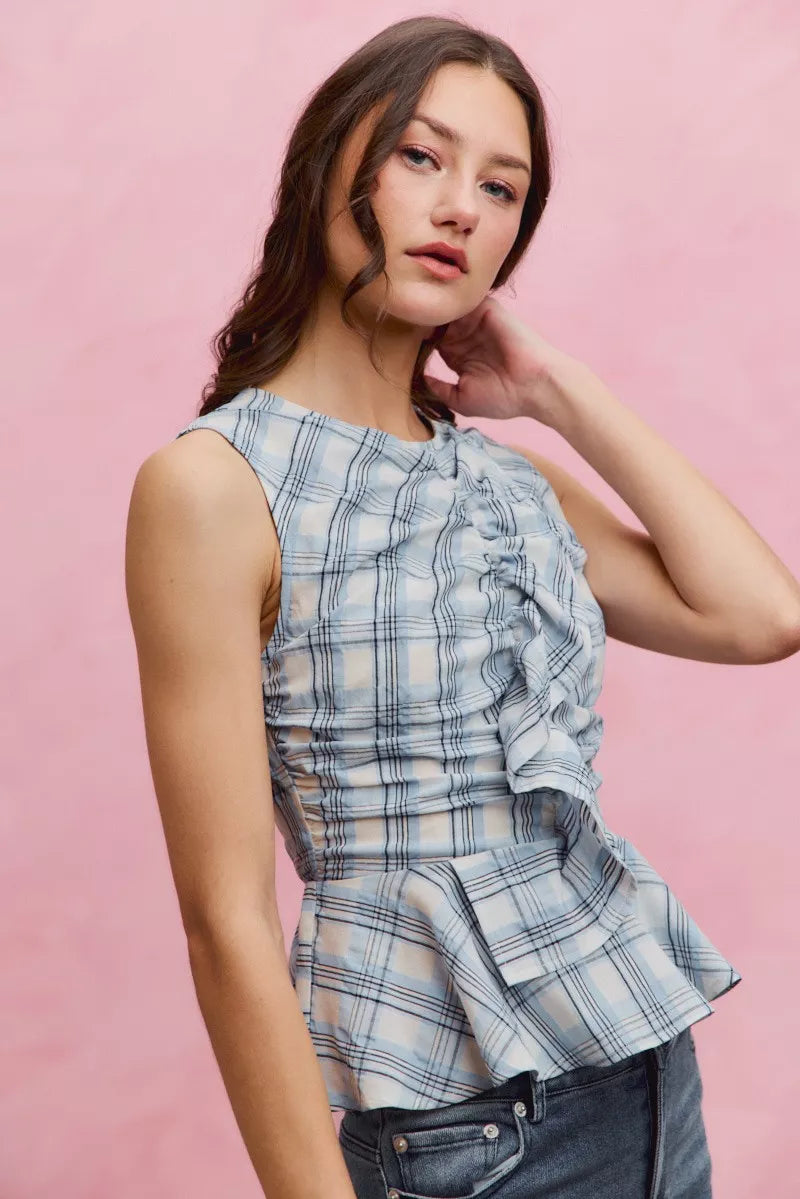 Plaid sleeveless ruffle peplum top by Plush Fashion Hub featuring a fitted waist and stylish ruffle details.