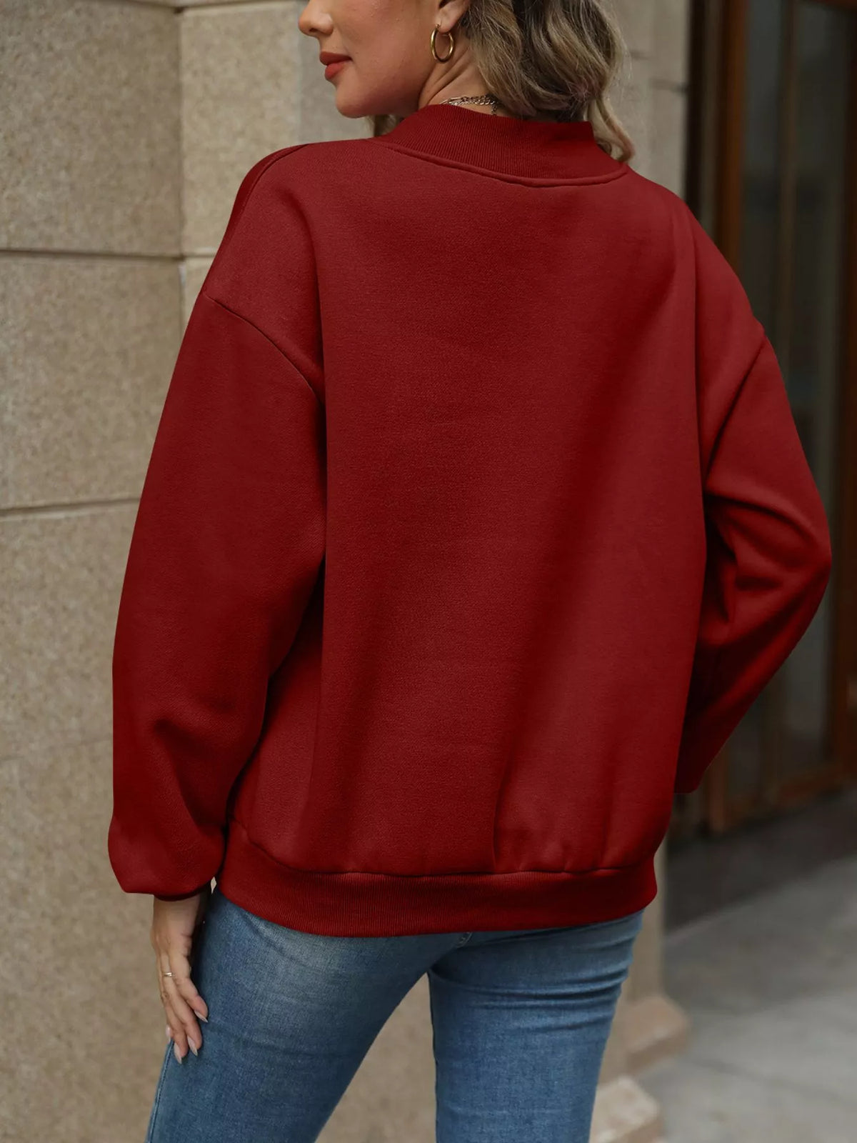 V-neck solid color casual sweatshirt by Trendsi, showing front view with relaxed fit and soft fabric in a neutral shade.