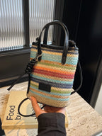 Striped woven mini crossbody bag with adjustable strap, featuring colorful horizontal stripes for trendy casual wear.