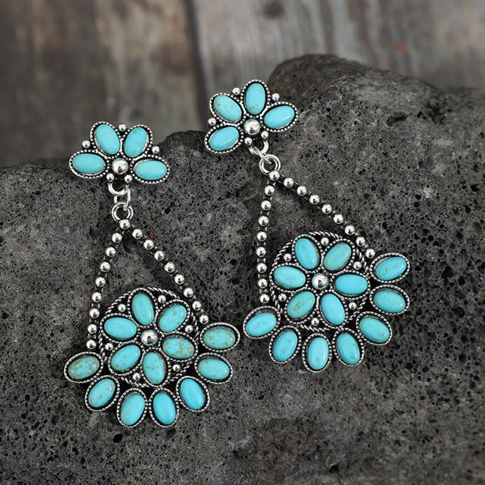 Artificial turquoise teardrop earrings with silver hooks, stylish jewelry accessory, from Plush Fashion Hub.