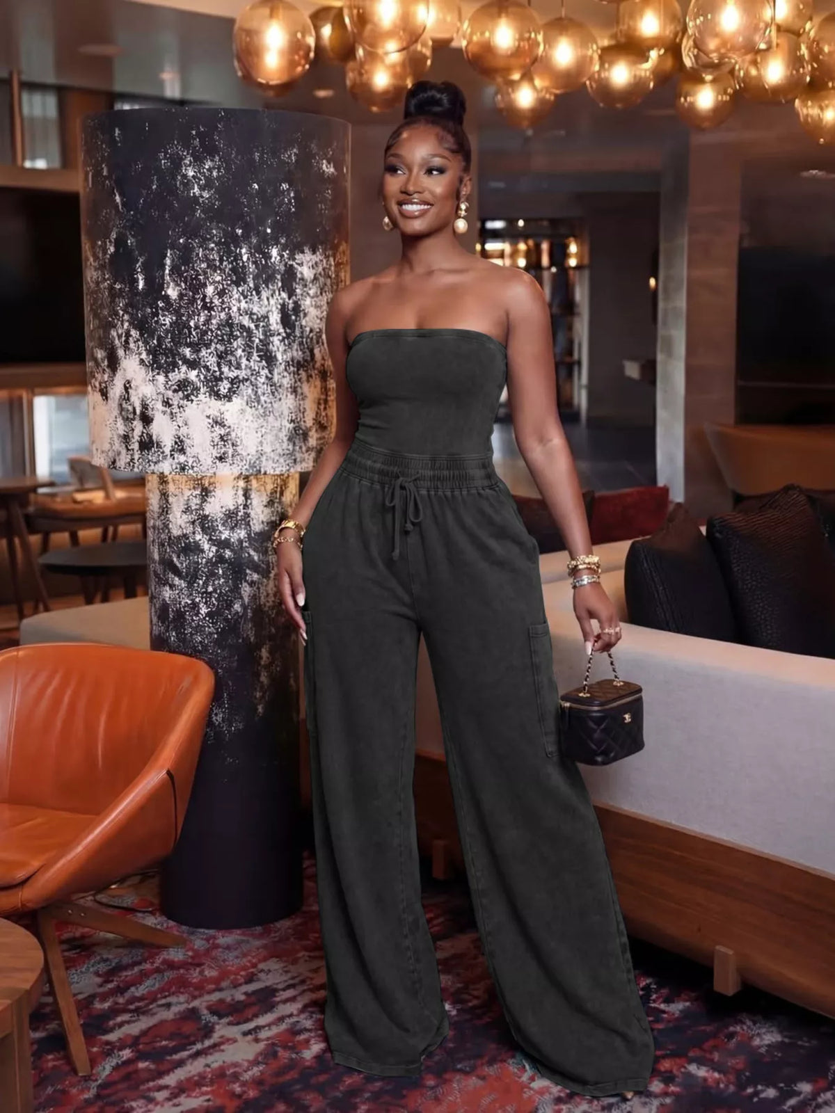 Strapless wide-leg jumpsuit with drawstring waist by Plush Fashion Hub, featuring a stylish playsuit design in a sleek fabric.