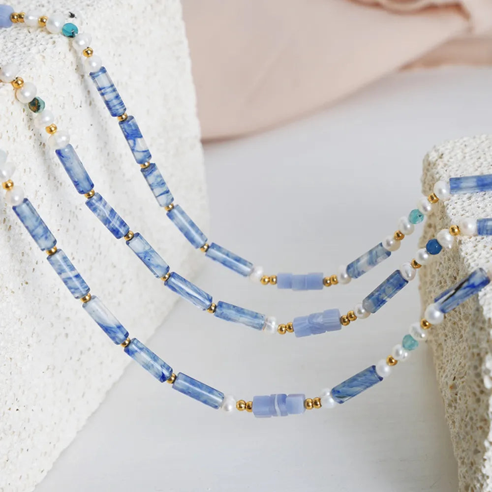 Freshwater pearl and titanium steel geometric bead necklace featuring modern design and elegant craftsmanship.