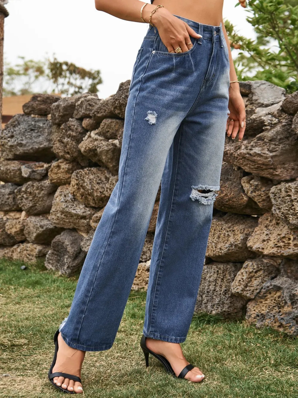 Distressed Plush Fashion Hub denim jeans with pockets, showing a casual fit and ripped detailing on the front.