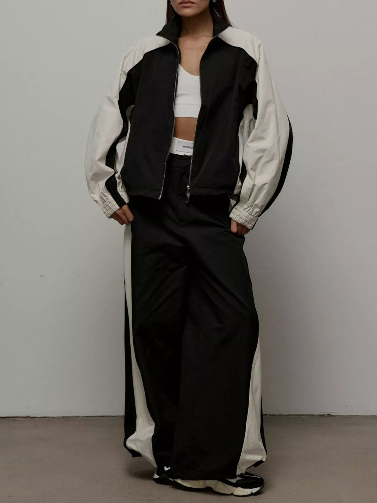 Color block zip-up outerwear and pants set by Plush Fashion Hub, featuring vibrant color blocks and a comfortable fit.