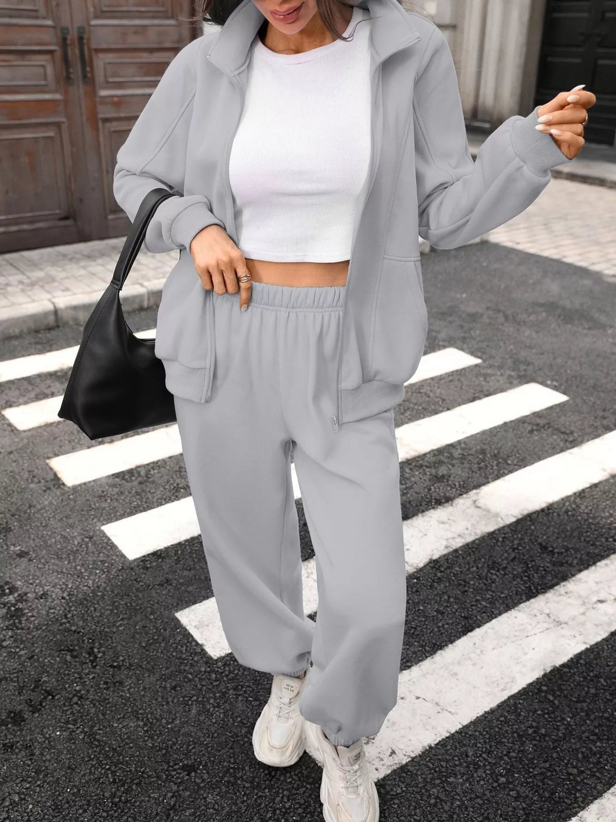 Women's zip-up long sleeve top and pants set by Trendsi, featuring a comfortable matching loungewear outfit.