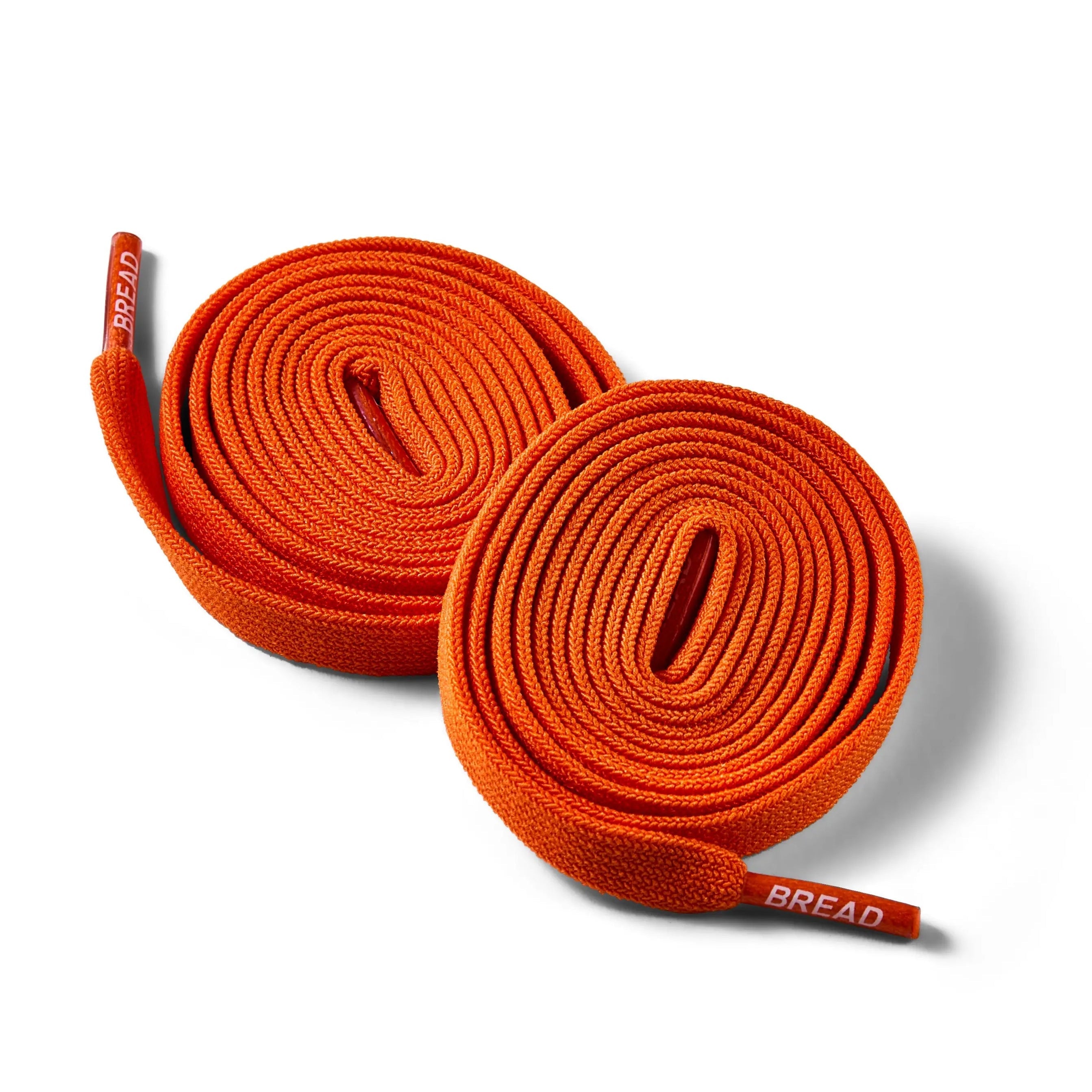 Coral orange elastic shoelace by Bread with flexible, stretchable design for sneakers or casual shoes.