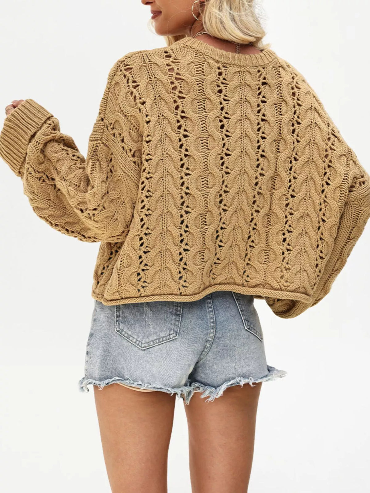 Chic cable knit half-button openwork sweater by Trendsi, showing the textured pattern and openwork details on the front.