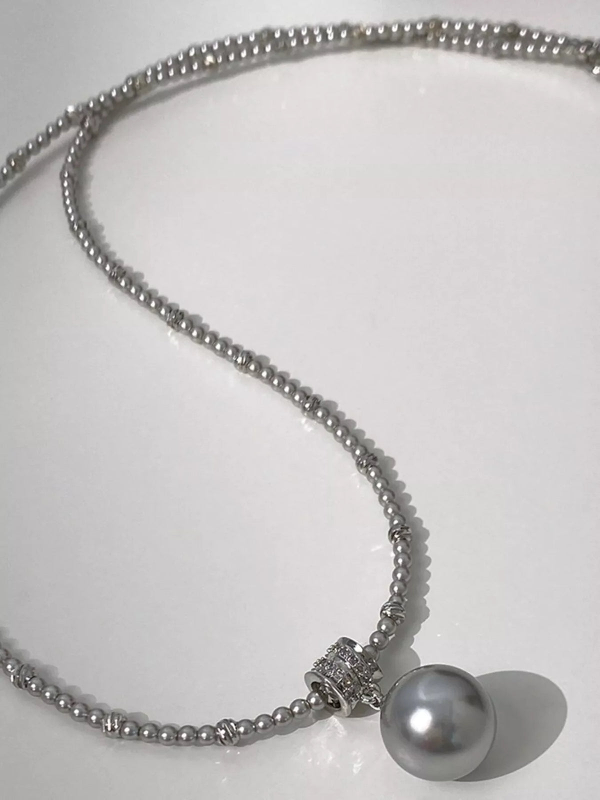 Elegant pearl pendant necklace from Plush Fashion Hub featuring a single lustrous pearl on a delicate chain.