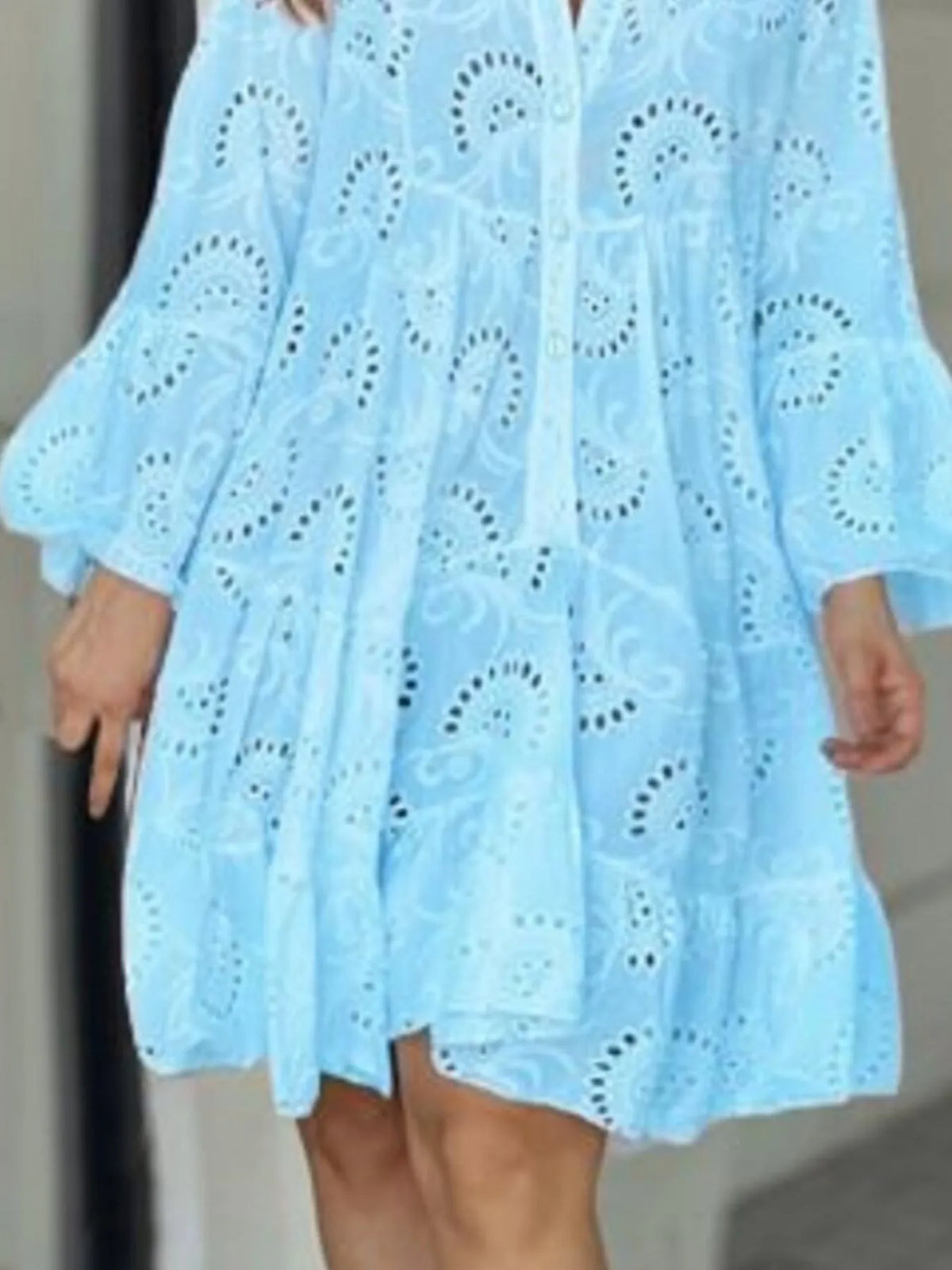 Plus size full-length eyelet ruffled hem tiered dress by Trendsi, featuring a flowing silhouette and intricate eyelet details.