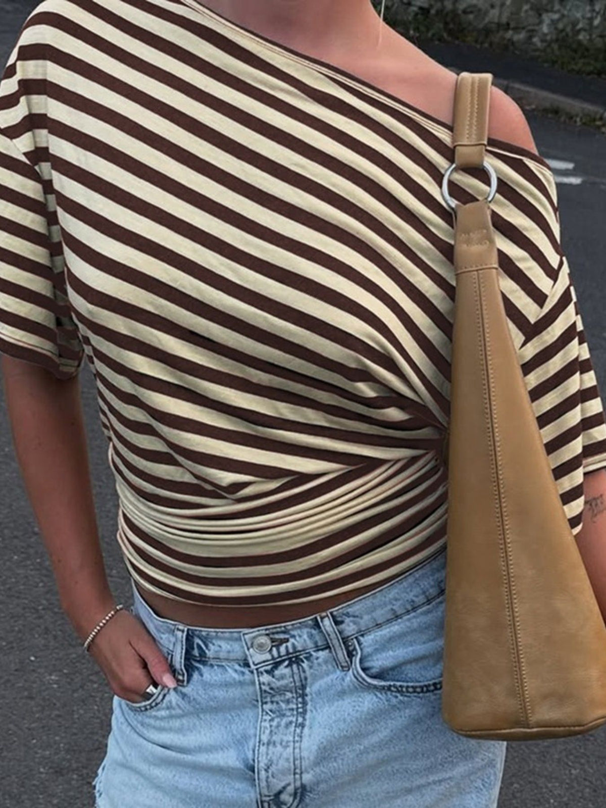 Women's asymmetrical striped one-shoulder T-shirt by Plush Fashion Hub, featuring a stylish design and vibrant pattern.