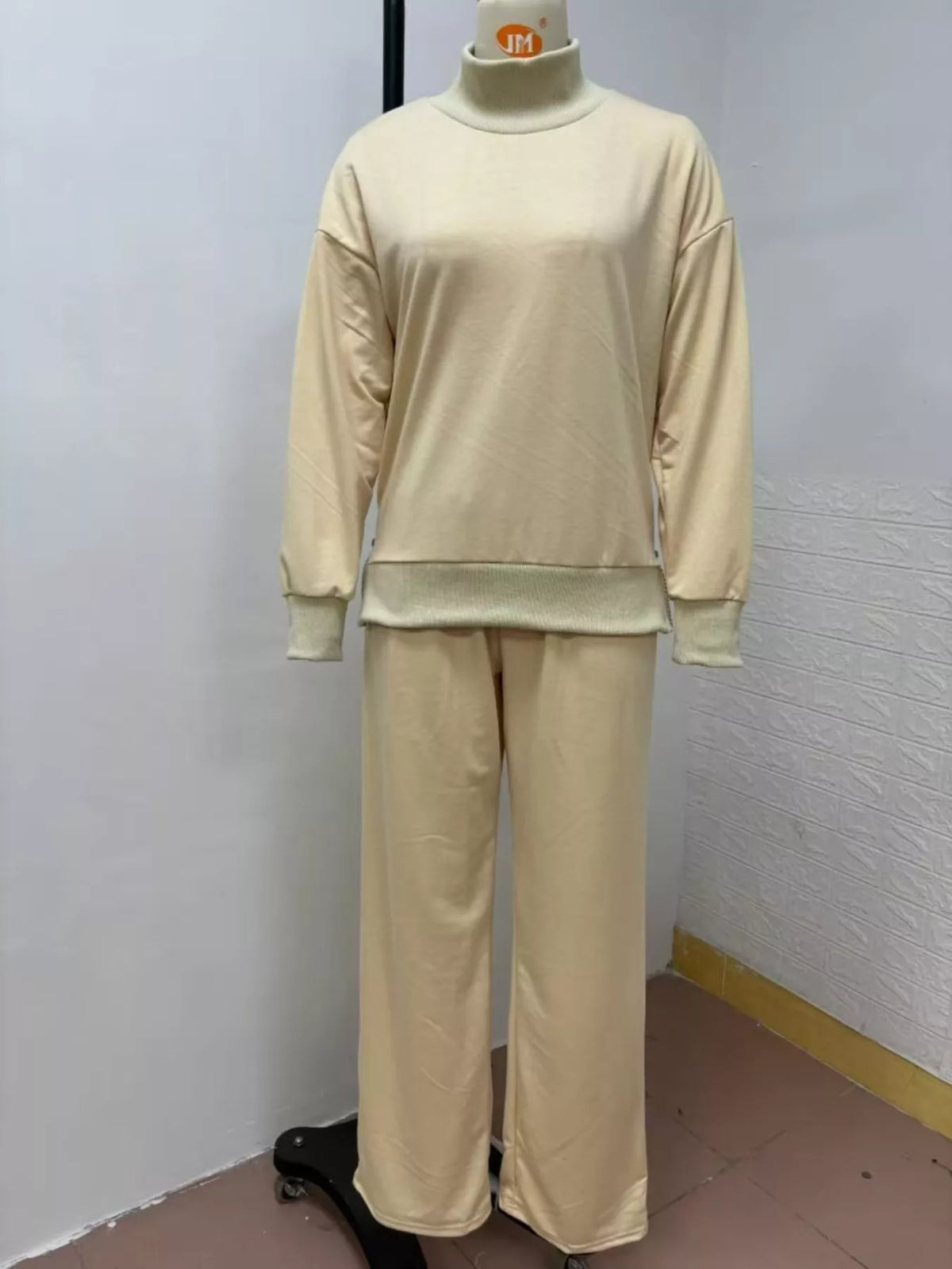 Trendsi turtleneck dropped shoulder top and matching pants set, stylish and comfortable outfit for casual wear.