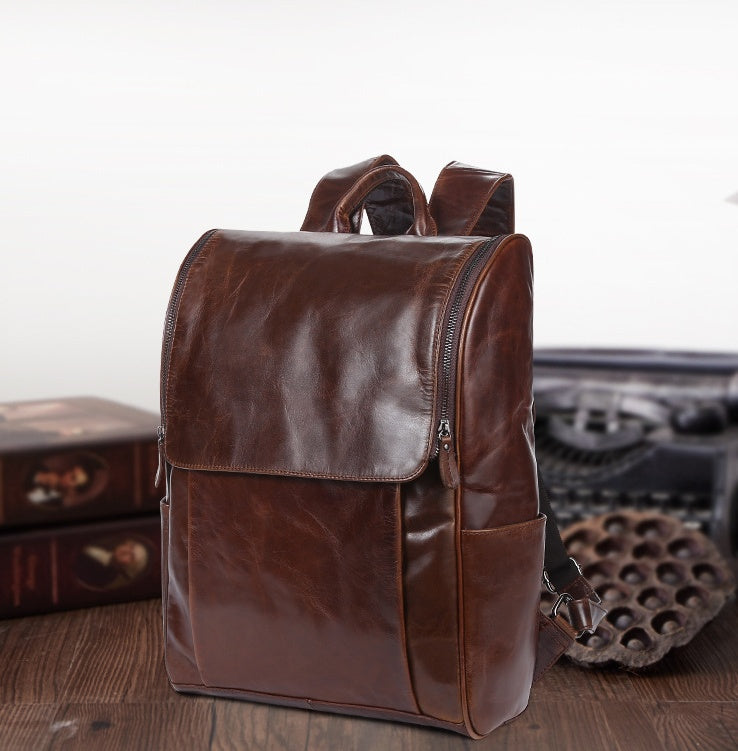 Black leather computer backpack from Pi-Mart, first layer leather bag with multiple compartments and padded shoulder straps.