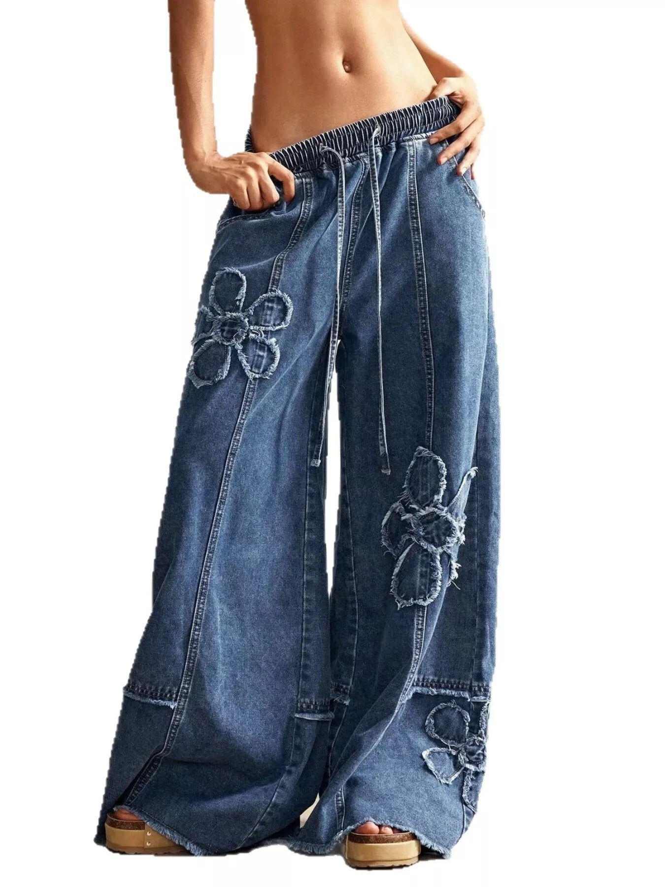 Wide leg jeans with floral appliques from Shopimist, featuring embroidered flower designs on denim.