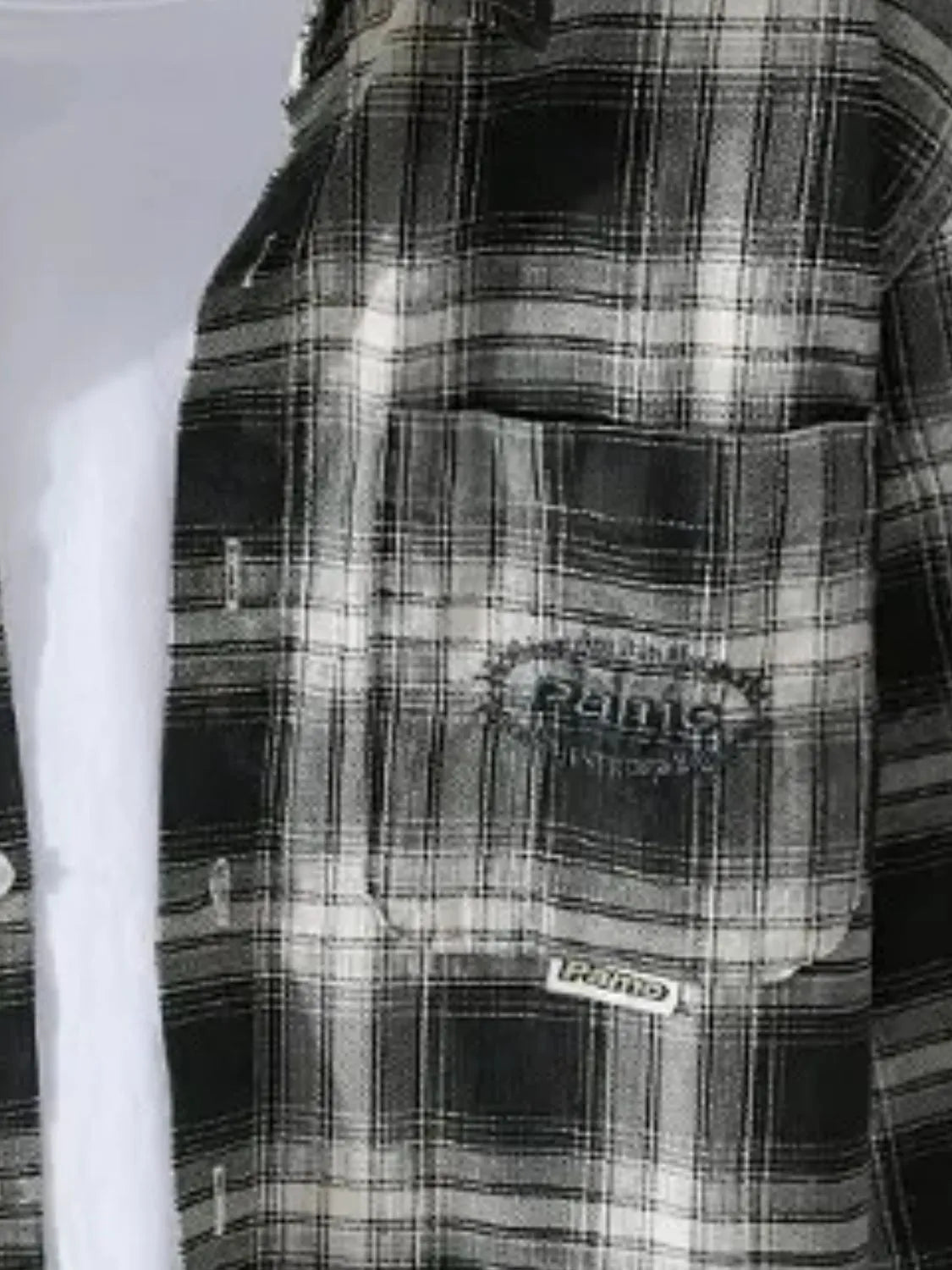 Men's plus size plaid button-up long sleeve shirt by Trendsi, shown in a classic pattern with a collar and button closure.