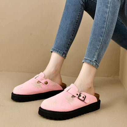 Round toe platform loafers in pink suede with a low heel, worn by a person in blue jeans.