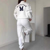 Women's white lounge pullover and sweatpants set featuring Michigan logo, stylish and comfortable for casual wear.