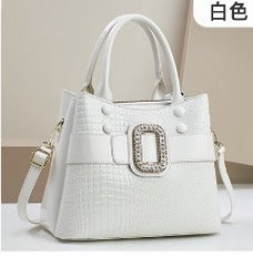 Lizard patterned mini bucket crossbody bag with zipper from Plush Fashion Hub, featuring a compact design and adjustable strap.