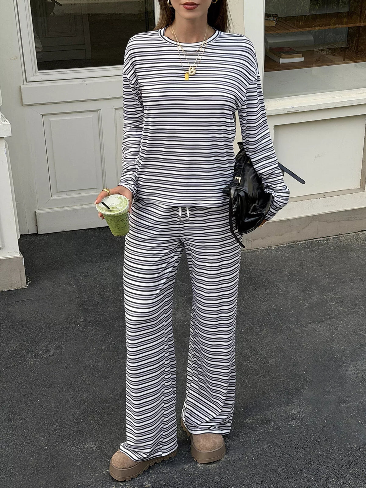 Women’s striped casual long sleeve top and wide-leg pants set by Trendsi, featuring a comfortable, stylish outfit with bold stripe patterns.