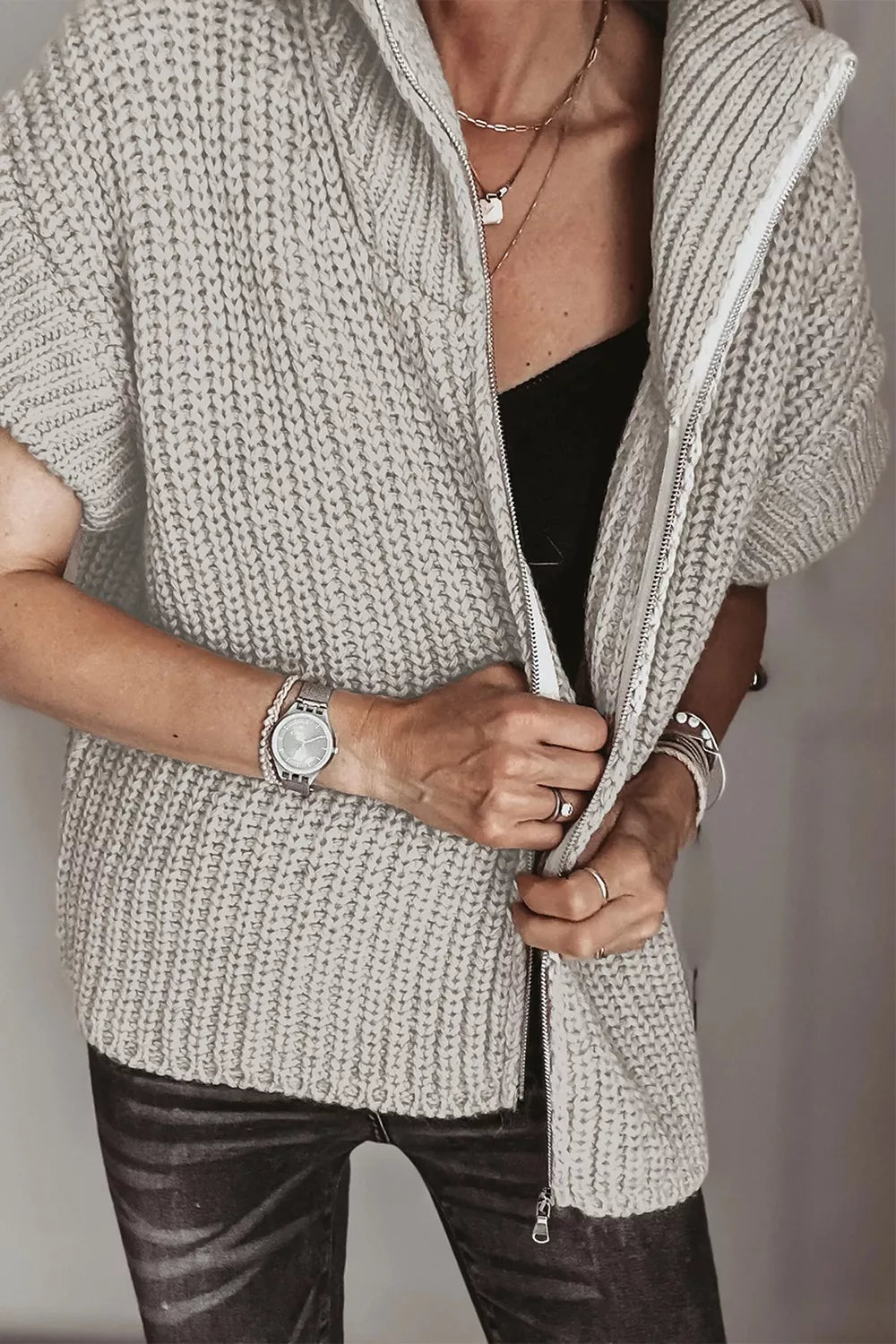 Solid color short sleeve zipper knit high neck sweater by Trendsi, featuring a fitted design and high neckline.
