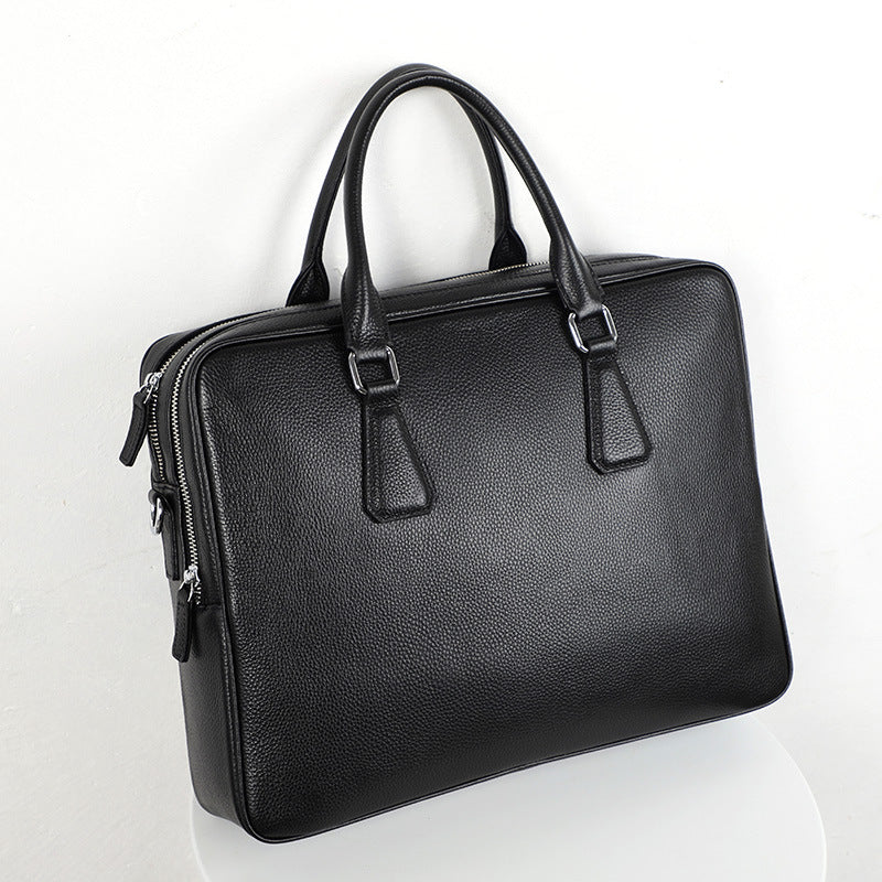 Men's leather briefcase by Pi-Mart, large capacity cowhide horizontal handbag with sturdy handles and spacious interior.