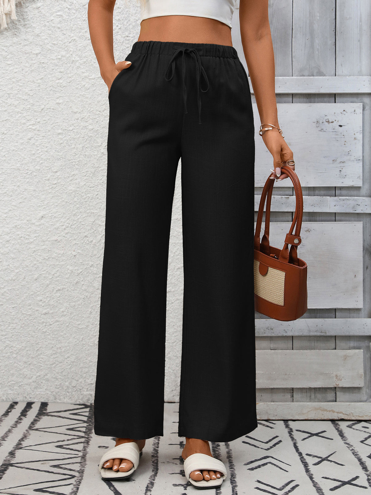 Women's high-waisted wide-leg drawstring pants in soft, breathable viscose with relaxed fit and elastic waistband from Plush Fashion Hub.