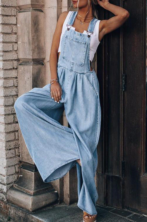 Women’s wide-leg denim overalls by FitiqueFit showing front view with adjustable straps and relaxed fit on casual model