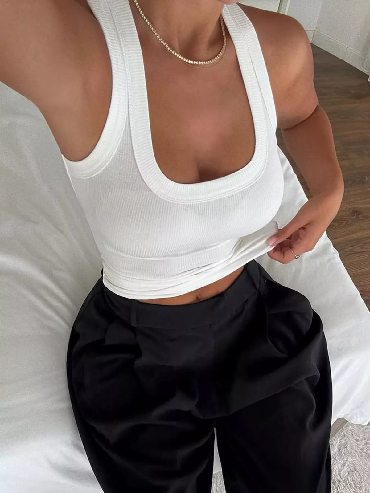 Solid color ribbed tank top by Plush Fashion Hub, featuring a fitted design and sleeveless style for casual wear.