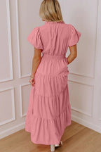 Women's floral maxi dress with ruffled tiers and puff sleeves, elegant long dress by Trendsi, showcased on a model.