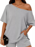 Plus size one-shoulder top and shorts set from Trendsi, featuring a stylish, coordinated casual outfit with a modern design.