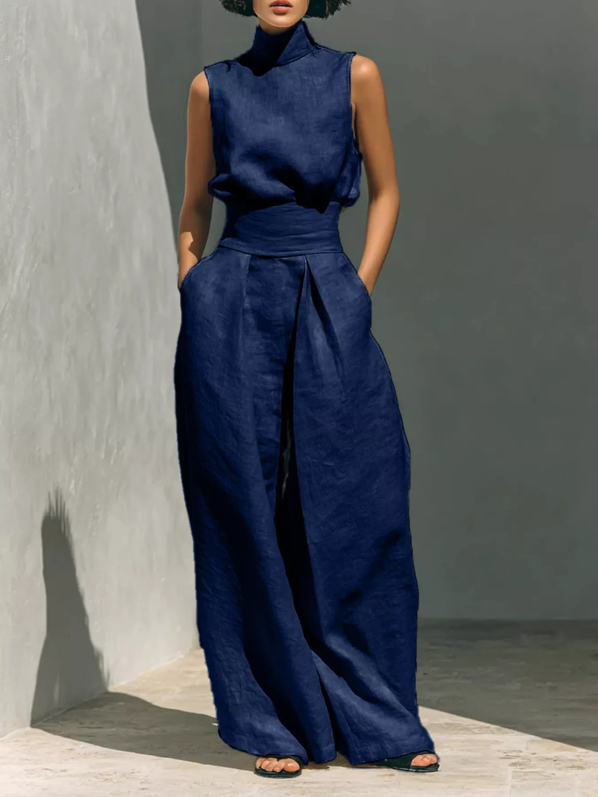 Plus size sleeveless wide-leg jumpsuit with smocked waist, full length, trendy design by Trendsi.