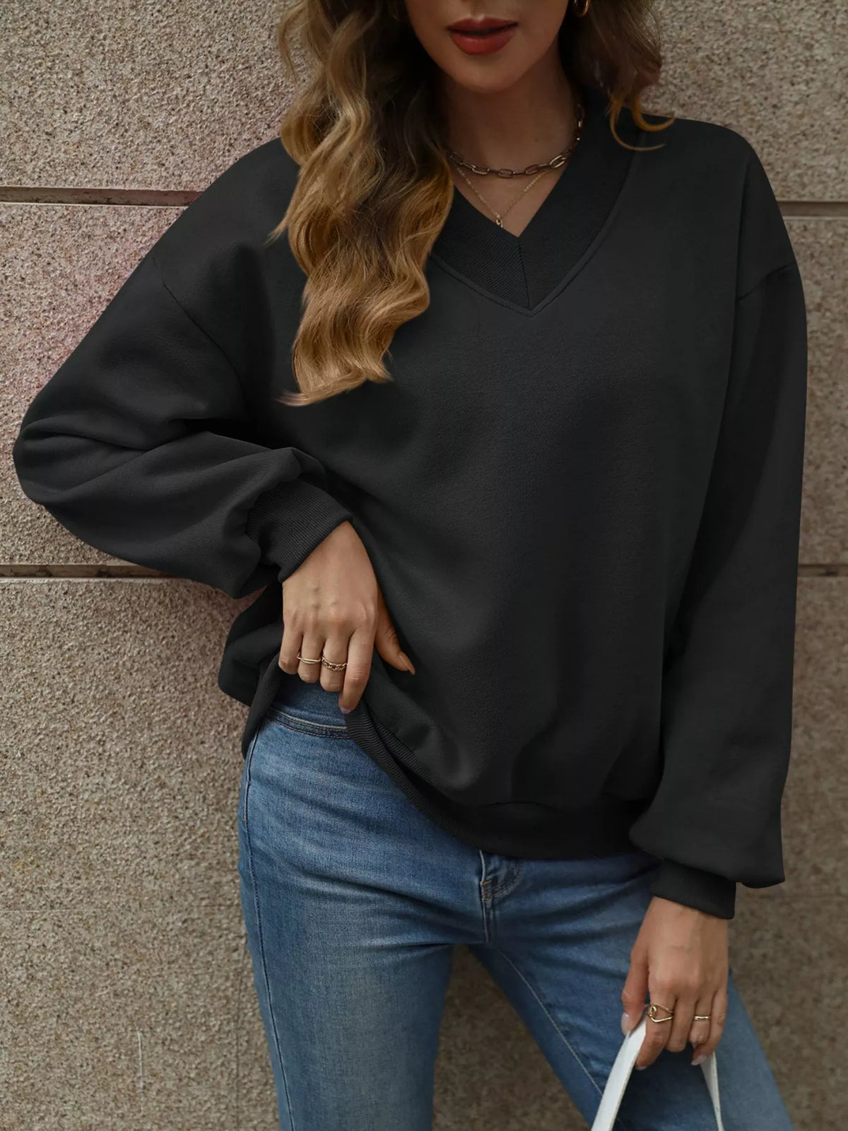 V-neck solid color casual sweatshirt by Trendsi, featuring a relaxed fit and long sleeves, displayed on a neutral background.