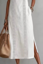 Women's sleeveless side slit maxi dress with pockets from Trendsi, featuring a flowing fabric and a stylish slit on the side.
