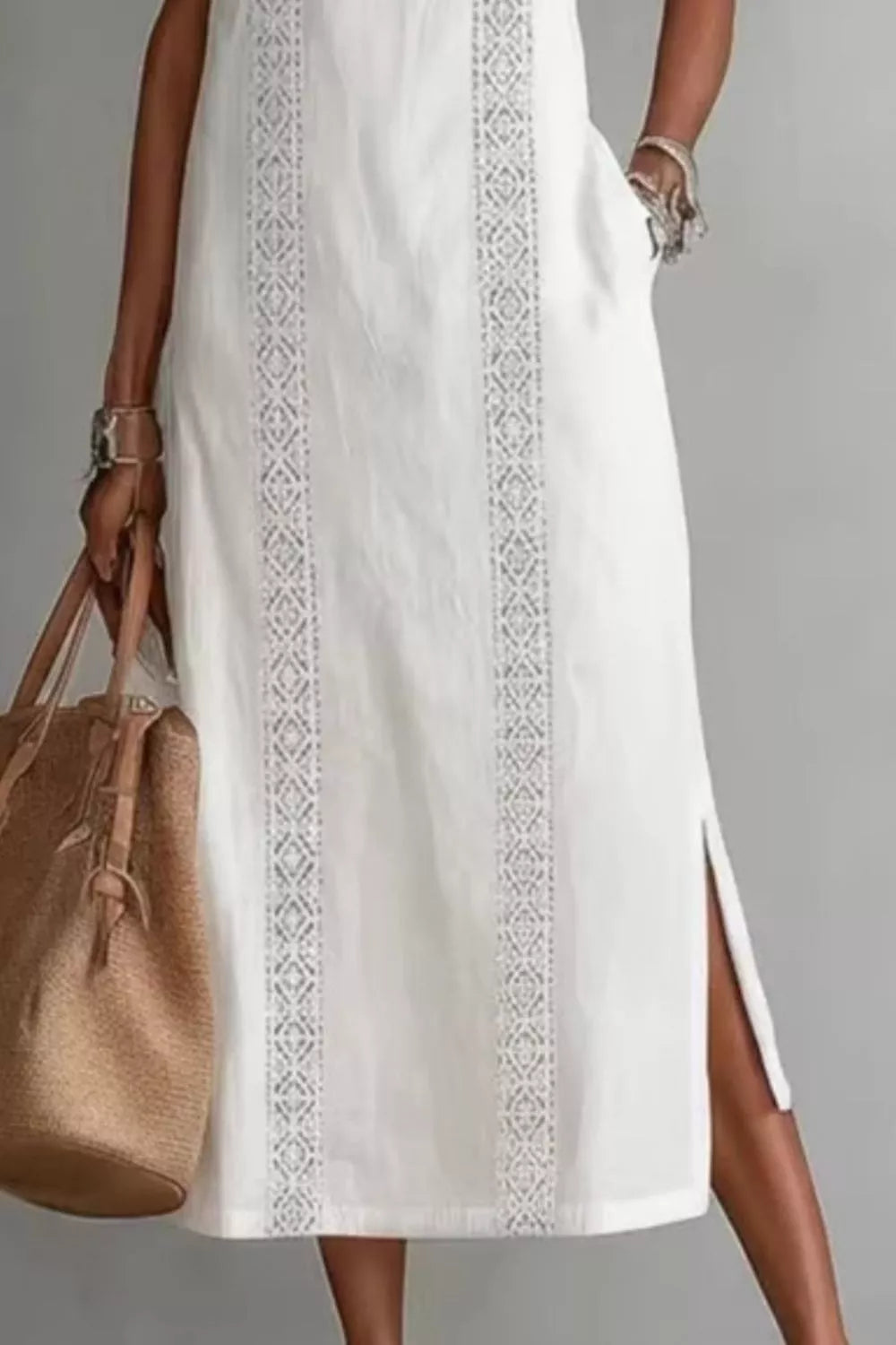 Women's sleeveless side slit maxi dress with pockets from Trendsi, featuring a flowing fabric and a stylish slit on the side.