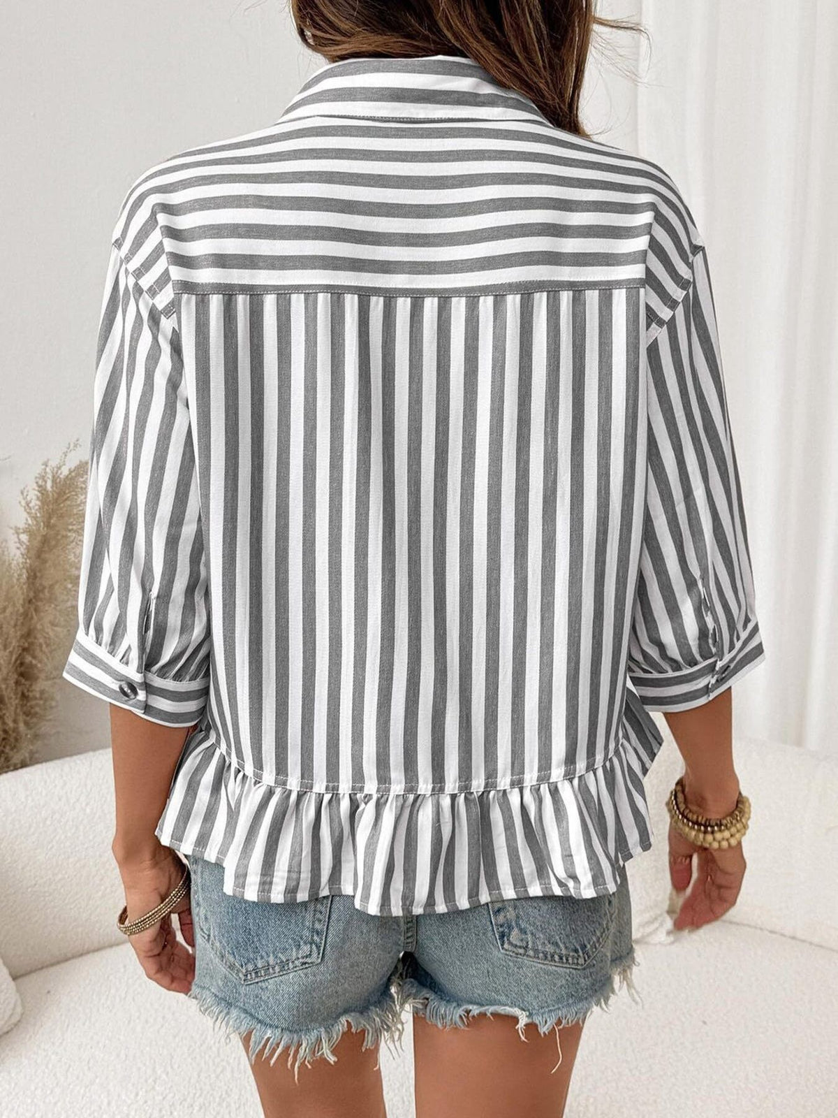 Women’s striped button-down blouse by Plush Fashion Hub, lightweight viscose fabric with ruffled hem and long sleeves.