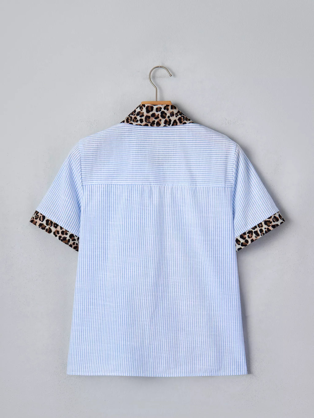 Women's leopard print short sleeve dress with contrast collar, stylish design by Trendsi, shown on a mannequin.