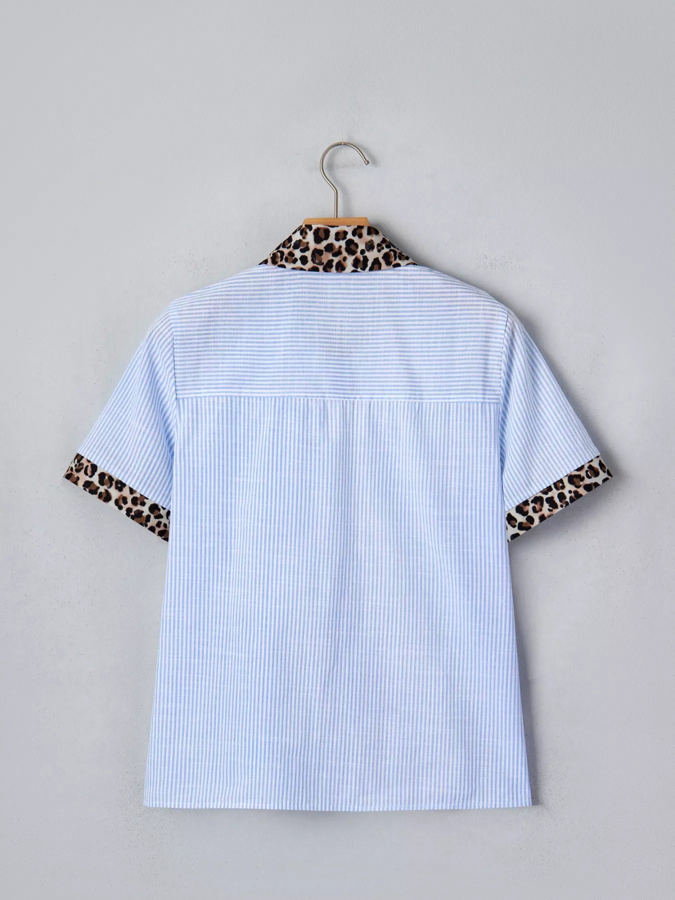 Women's leopard print short sleeve dress with contrast collar, stylish design by Trendsi, shown on a mannequin.