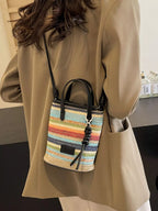 Striped woven mini crossbody bag by Trendsi, featuring a compact design with adjustable strap and colorful woven pattern.