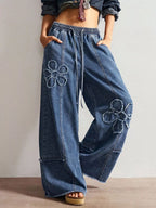 Shopimist floral appliques wide leg jeans with embroidered floral patches and relaxed fit, showcasing stylish denim design.