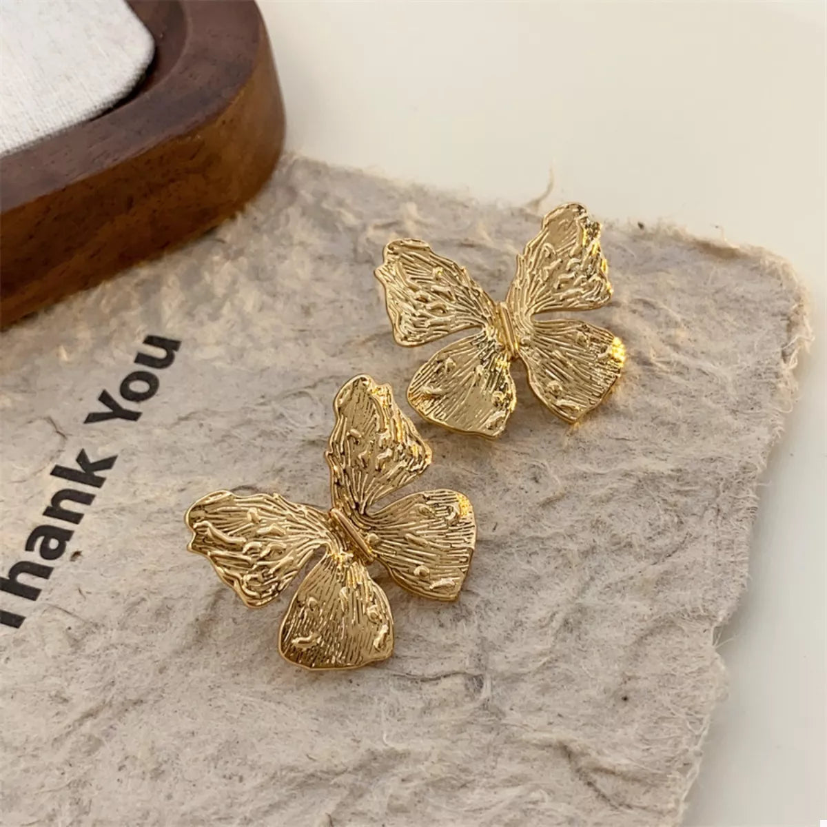 Gold-plated textured stud earrings from Plush Fashion Hub, stylish and elegant jewelry accessory.