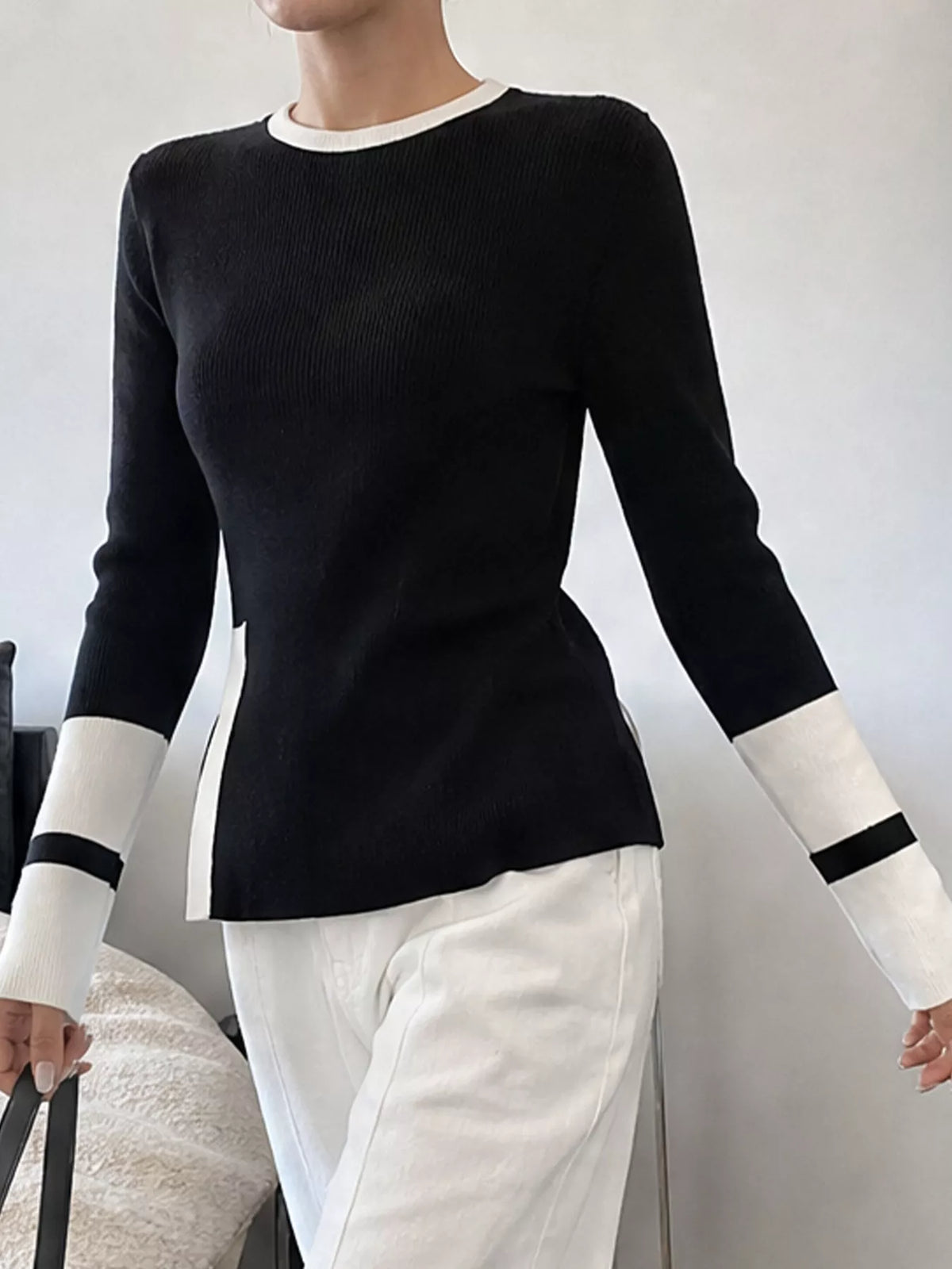 Light gray sweater with side slit and contrast trim, stylish knit sweater from Trendsi featuring a relaxed fit.