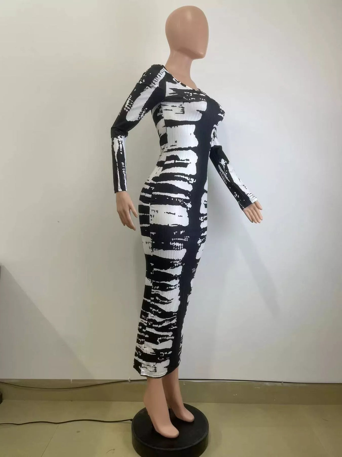 Colorful tie-dye long sleeve maxi dress by Plush Fashion Hub featuring a flowing silhouette and vibrant patterns.
