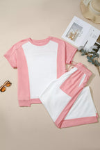 Two-tone color block patchwork tee and drawstring loose pants set by Trendsi, featuring casual, comfortable matching top and bottom ensemble.