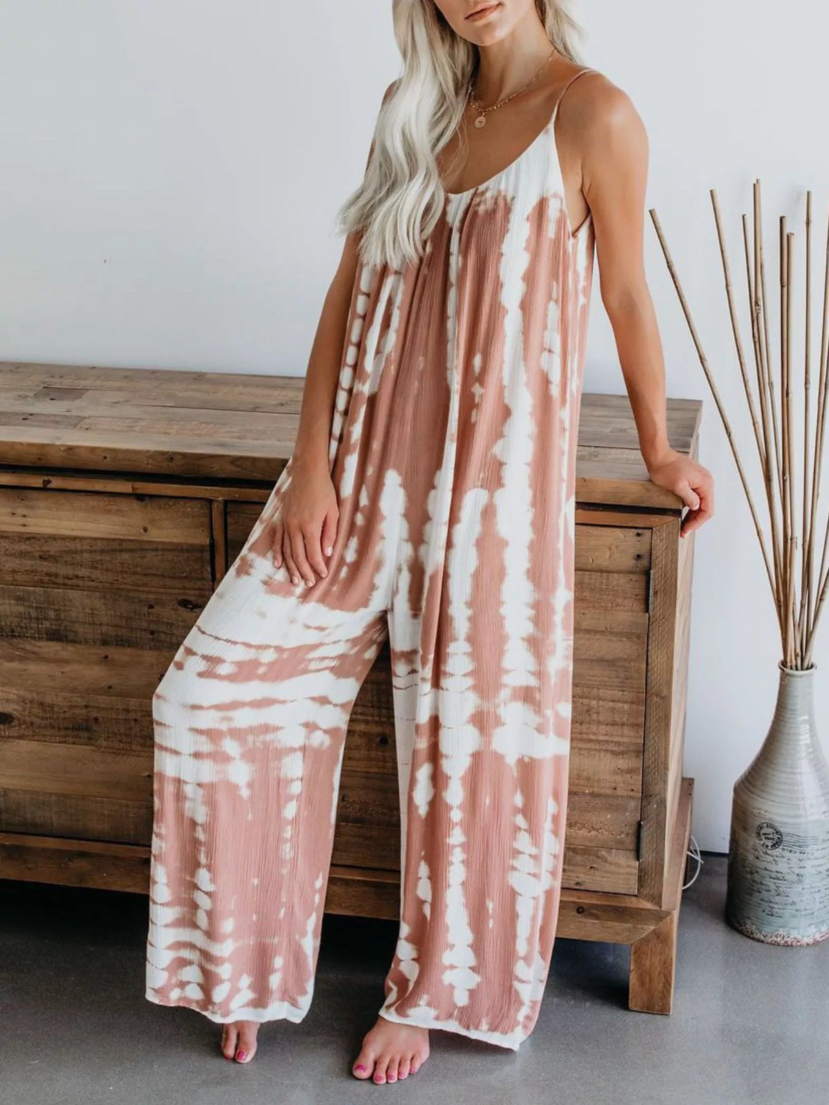 Full size tie-dye wide-leg jumpsuit by Plush Fashion Hub, featuring a vibrant pattern and relaxed fit for plus size wear.