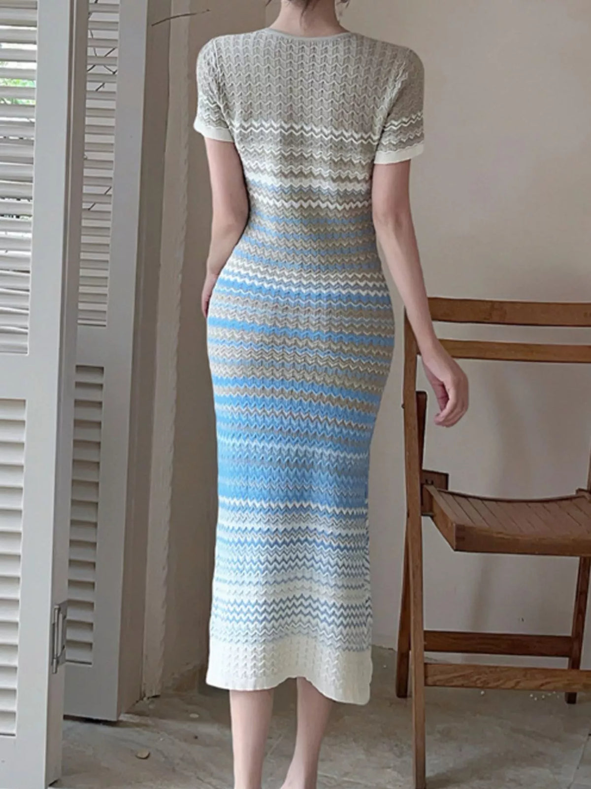 Gradient knit striped short sleeve midi dress by Trendsi, showcasing a colorful pattern and comfortable fit.