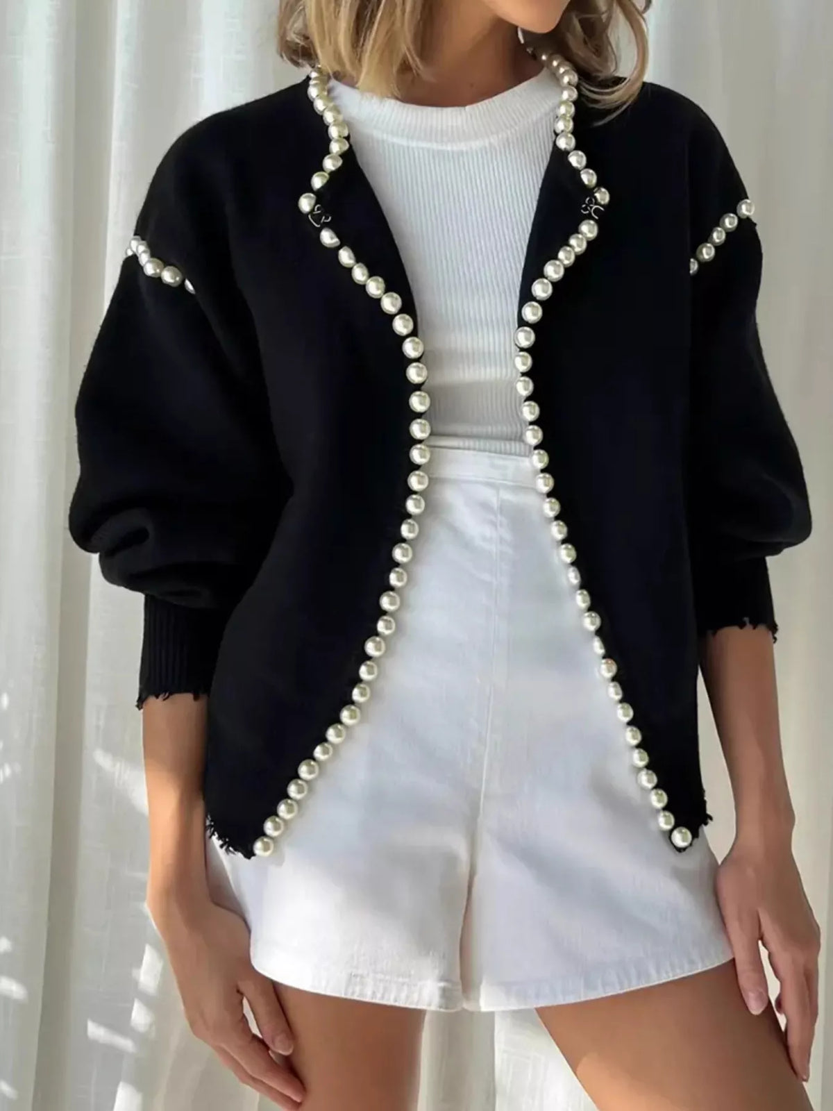 Pearl-trimmed open front women's cardigan by Trendsi, featuring a soft knit fabric and stylish design, displayed on a hanger.