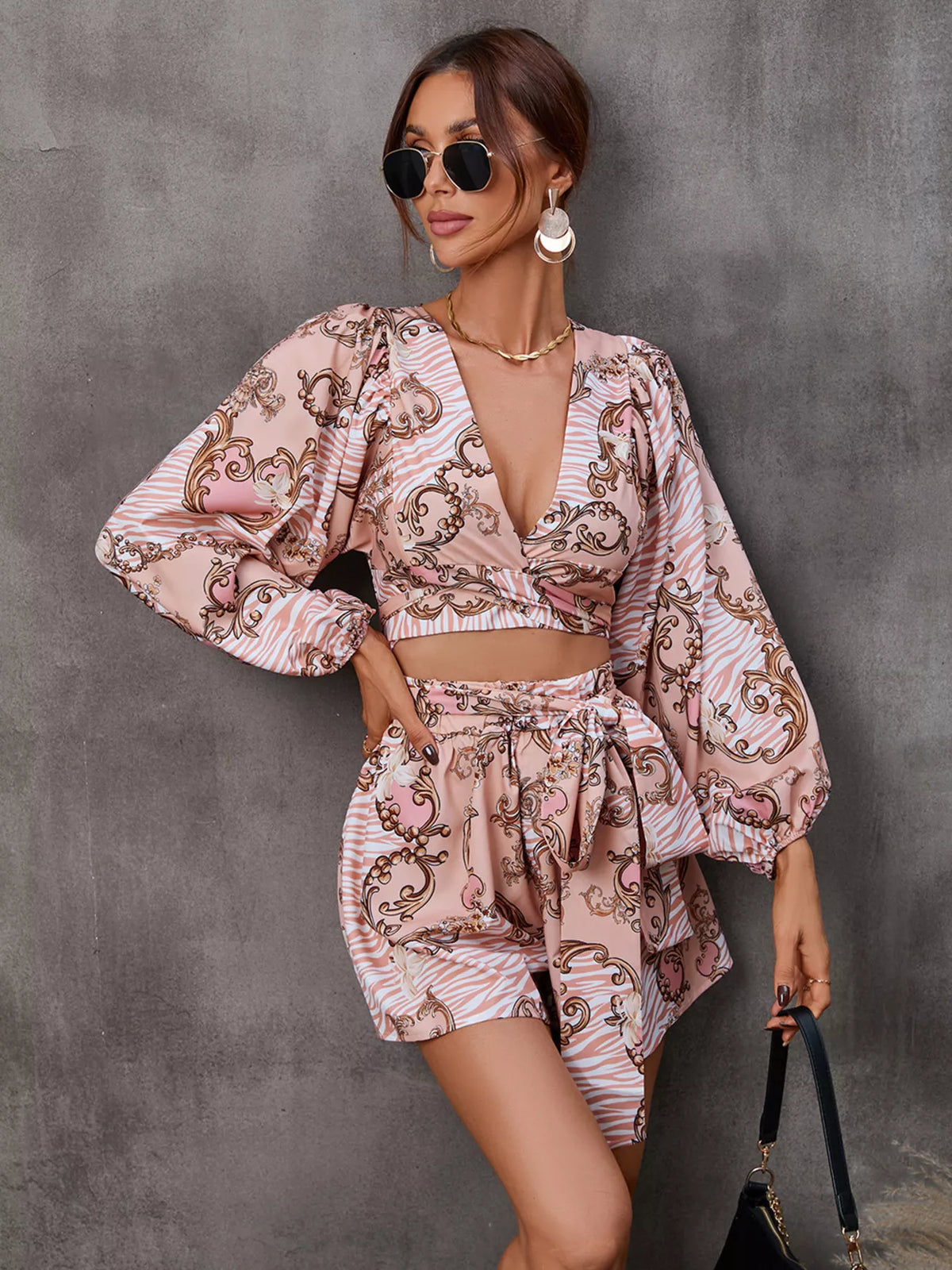 Printed long sleeve romper with front cutout, stylish jumpsuit by Plush Fashion Hub, shown in the product image.
