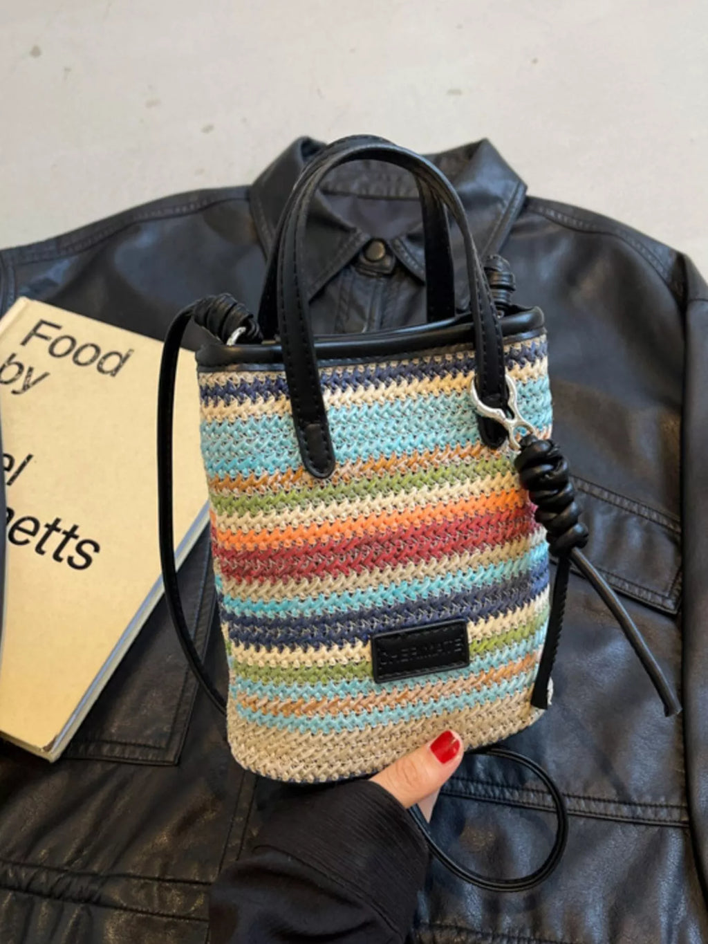 Striped woven mini crossbody bag by Trendsi featuring a compact design with a colorful striped pattern and adjustable strap.